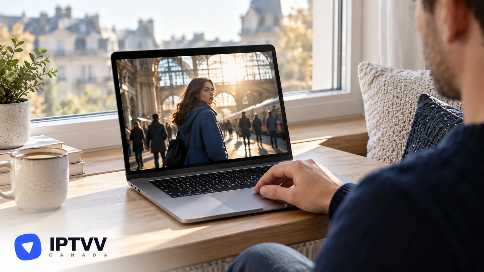 Hands on a MacBook playing a film scene on a city street